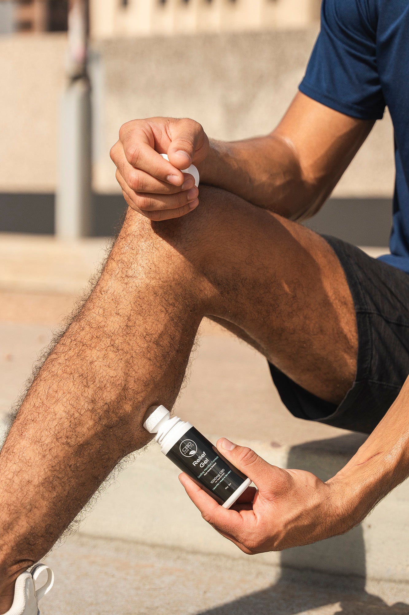 A man applying CBD relief gel to his leg