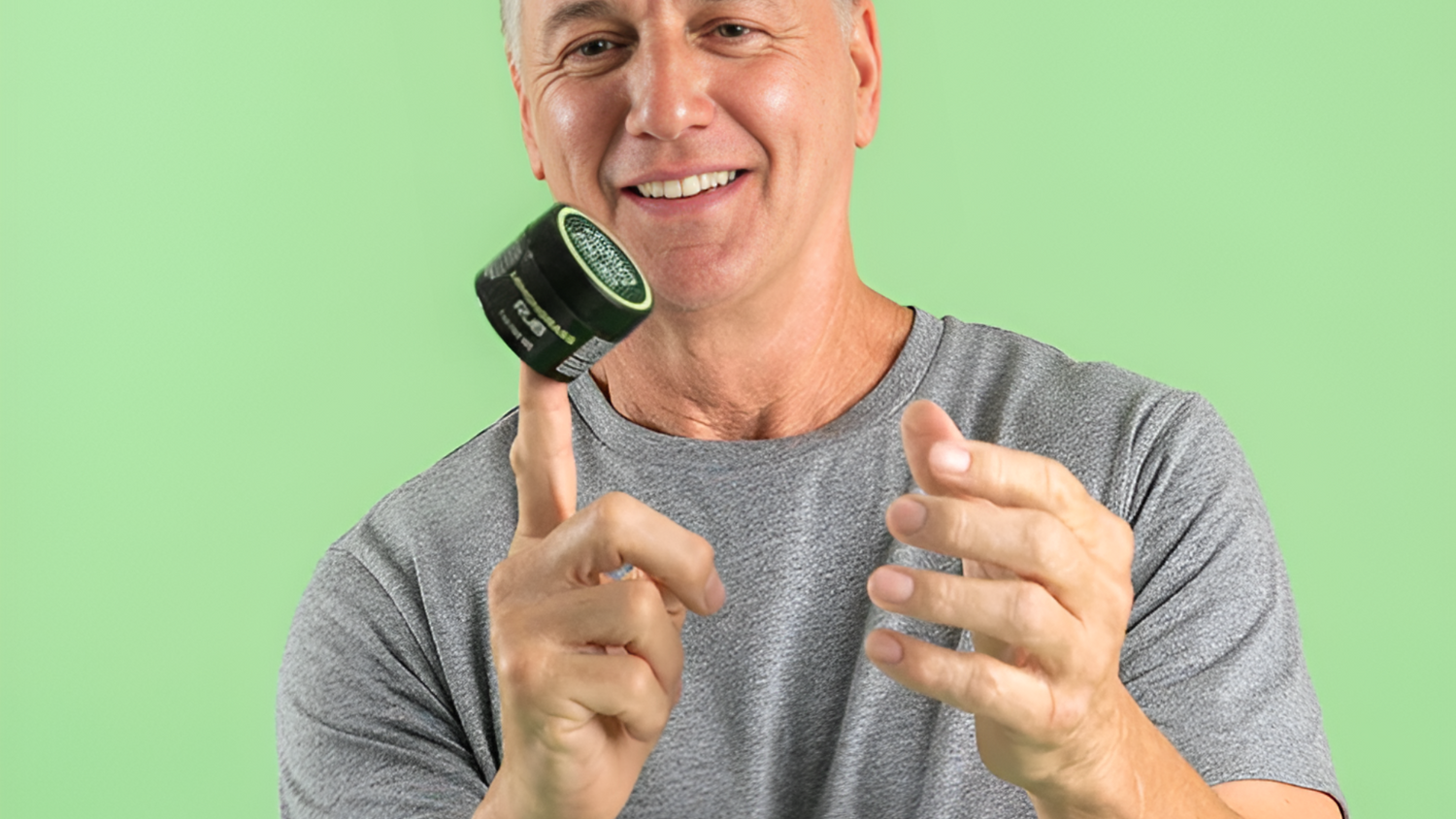 Man demonstrating CBD topical rub jar balanced on index finger