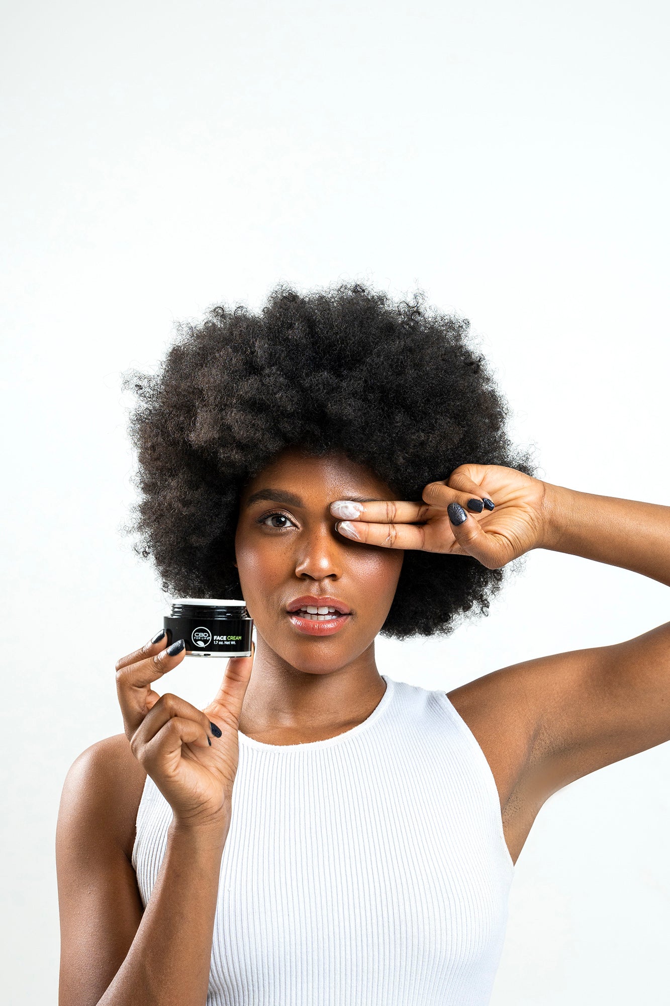 Woman using CBD face cream