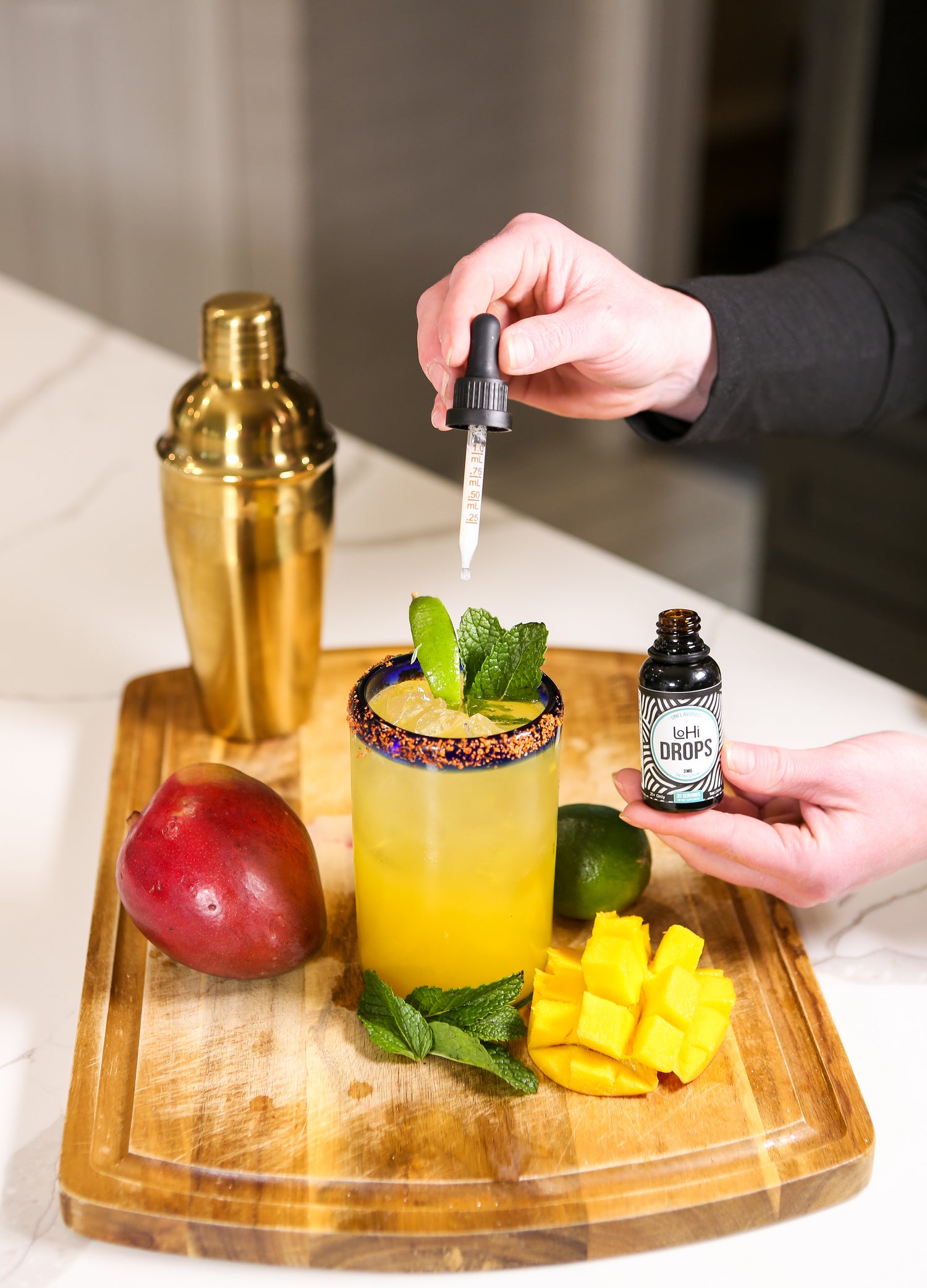 Adding LoHi THC drops from CBD for Life to a mango mocktail