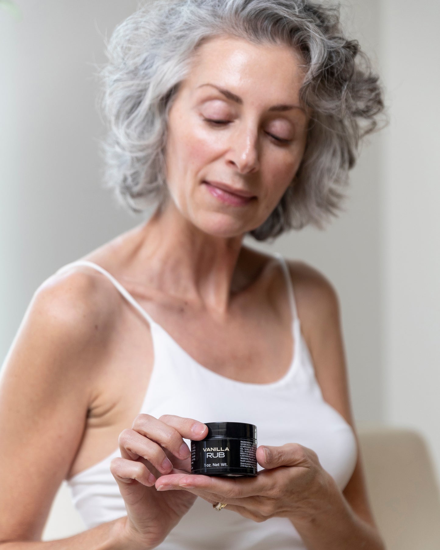 Woman using CBD rub for relief